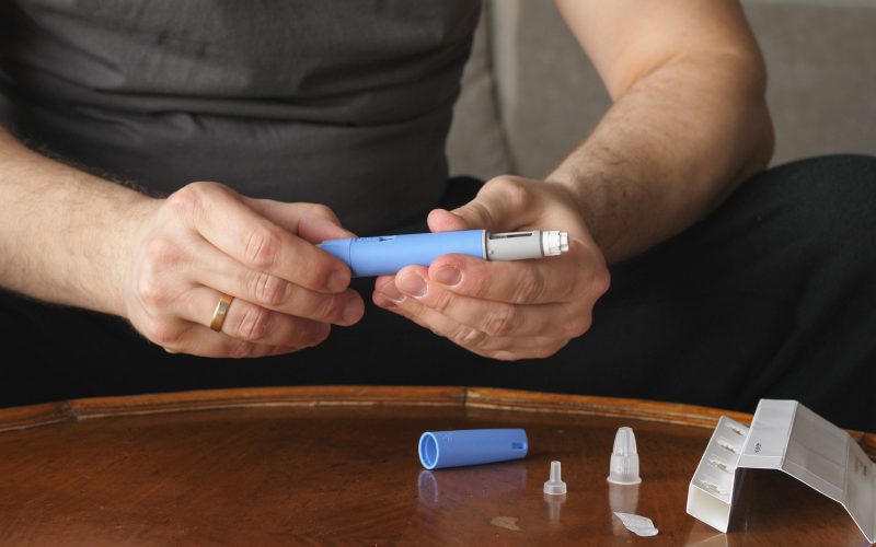 obese fat man preparing Semaglutide Ozempic injection control bl